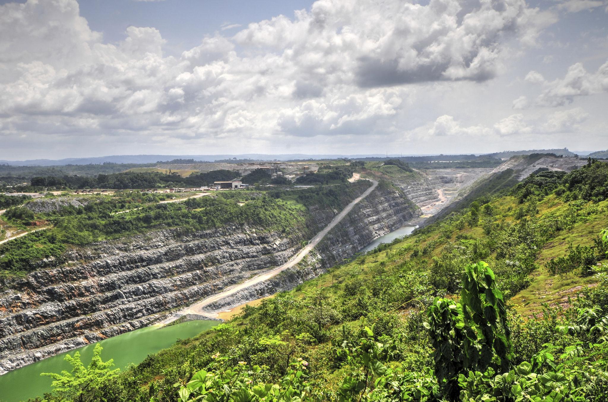 Terraced open-pit mine with haul roads and operational equipment